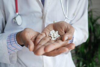 Γιατρός κρατάει στα χέρια του χάπια