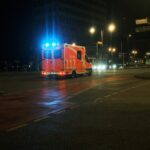 Tram stopped on tracks in Munich during night with rescue vehicles nearby
