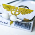 German health insurance card on euro bills symbolizing lawsuit over Bürgergeld health care costs