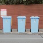 Waste collectors inspecting brown bio-bins in a German residential street