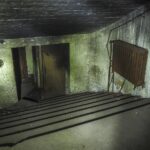 Reinforced bunker door in a basement designed as protective shelter