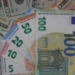 Euros and dollars symbolizing wealth comparison between Germany and USA