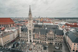 Apprentices leap into the Fischbrunnen fountain at Munich’s Marienplatz during the Metzgersprung tradition