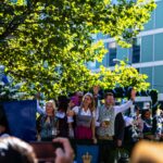 Oktoberfest visitors enjoying beer in a sunny outdoor garden in Munich