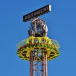 Jules Verne Tower swing carousel at Oktoberfest in Munich lit up at night