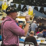Guests enjoying food and drinks inside a decorated Oktoberfest tent in Munich