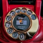 Senior using a traditional landline phone in Germany affected by Telekom tariff increase