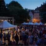 Visitors enjoying the Berg am Laim Neighbourhood Week festival in Munich.