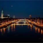 Aerial view of Bremen city at night with bright streets and the river Weser