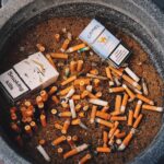 Discarded cigarette filters on the street representing environmental pollution