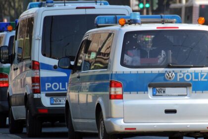 Police vehicles and officers outside Frankfurt police station during misconduct investigation