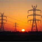 ower transmission lines in Germany representing electricity grid fee reductions in 2026