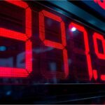 Digital price display at German petrol station illustrating fluctuating fuel costs