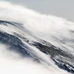 Snowless ski slopes in the Bavarian Alps under clear winter sky