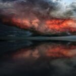 Stormy skies and coastal winds in northern Germany with snow visible on the Bavarian Alps