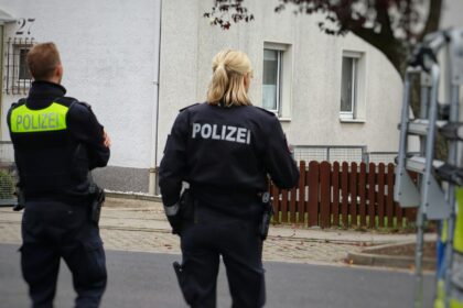 Police vehicles outside a residential building in Herdecke after knife attack on mayor