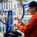 Mechanic checking a bicycle at a free safety event in Munich