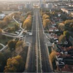 Aerial view of Munich showing Olympic Park and U-Bahn line, symbolising debate over new investments