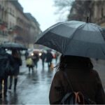 People walking with umbrellas in rainy Munich as strong winds sweep through the city