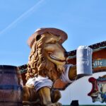 Visitors at Munich Oktoberfest holding soft drinks inside a beer tent