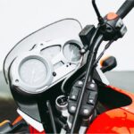 Pope Francis sits on a white BMW R18 motorcycle signed for charity auction