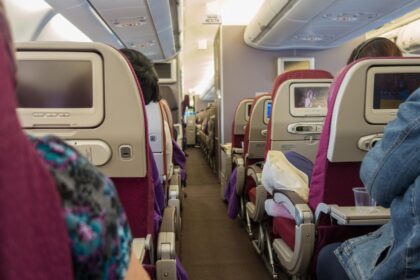 Airplane cabin with a passenger seat located next to the restroom door