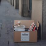 “Zu verschenken” cardboard box on German sidewalk representing new fine regulations