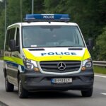 German police car stopping a vehicle on the A1 motorway during traffic investigation