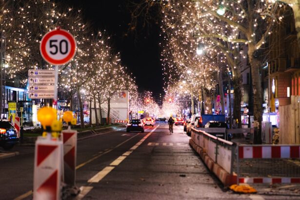 Visitors walk through a German Christmas market in the evening, with festive lights, crowded stalls and visible security presence.