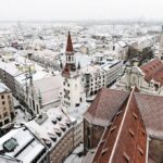 Light snowfall covering fields and low hills during an early winter cold spell in Germany.