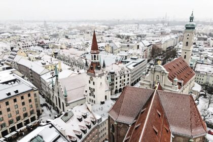 Light snowfall covering fields and low hills during an early winter cold spell in Germany.
