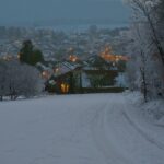 Light snowfall and icy road conditions in a German upland region during early winter.