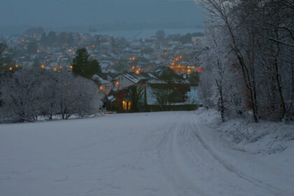 Light snowfall and icy road conditions in a German upland region during early winter.